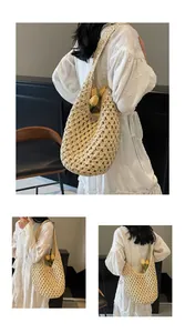 Detailed close-up showing hollow woven paper rope texture of the beige straw shoulder bag