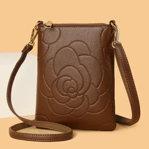 Brown lychee leather crossbody phone bag with embossed rose pattern and gold hardware