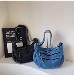 Detailed view of casual denim hobo bags featuring double front zippers in grey and blue
