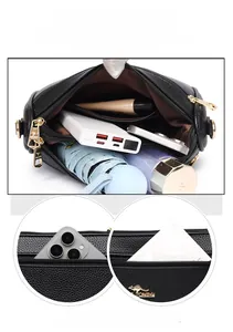 Detail view of large capacity black leather crossbody bag showing inner storage space
