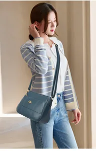Peacock blue leather handbag with diamond quilted stitching and gold logo plate