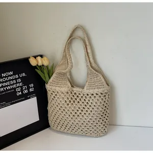 Detail of hand-woven crochet hobo bag with a mesh texture and fabric lining