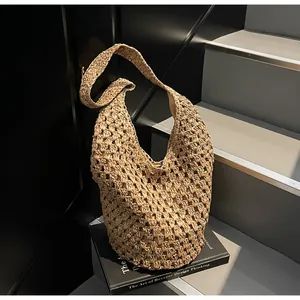 Close-up of the intricate hollow-out crochet texture on a paper rope woven shoulder bag