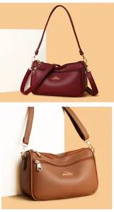 Close-up of multi-zipper compartments and lychee pattern texture on the crossbody bag