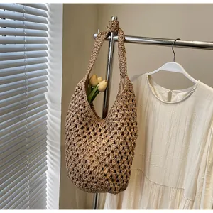 Detail of hollow paper rope woven bag with sturdy shoulder straps and inner fabric lining