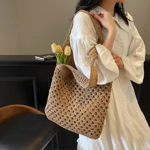 Stylish woven straw tote bag for women featuring a minimalist cutout crochet texture