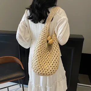 Hollow out woven straw shoulder bag in beige for beach trips and casual summer style