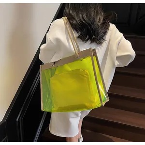 Detail of neon green PVC tote bag featuring braided rope handles and matching inner pouch
