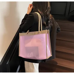 Detail of transparent purple tote bag with hemp rope handles and a pink inner pouch