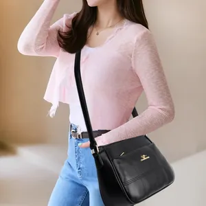 Classic black leather crossbody bag for middle-aged women featuring gold kangaroo logo