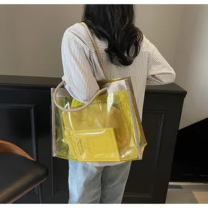 Detail of yellow transparent PVC tote with rope handles and inner pouch on shoulder