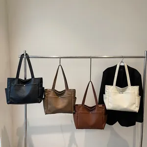 Large capacity vintage tote bags in four colors hanging on a metal display rack