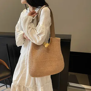 Natural straw tote bag with brown leather straps and spacious woven interior
