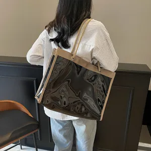 Large black transparent tote bag with thick rope handles and khaki fabric trim details