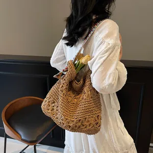 Handwoven straw tote bag with colorful ethnic strap and floral crochet pattern