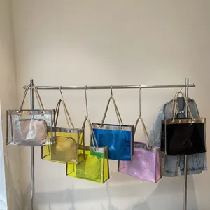 Transparent PVC tote bags in multiple colors with woven handles on a display rack