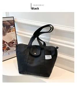 Detail view of the durable black canvas tote bag with fashion tag and front flap closure