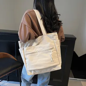 Grand sac fourre-tout en toile beige au design minimaliste pour le travail et l'école