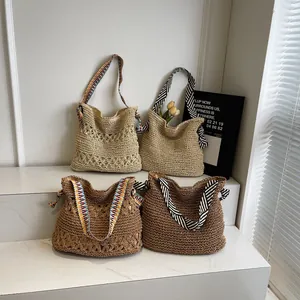 Handwoven straw tote bag with floral hollow patterns and bohemian shoulder straps