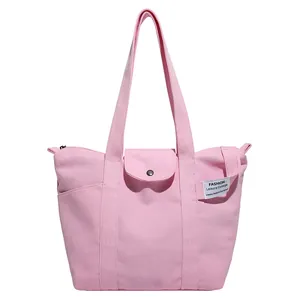 Pink canvas tote bag for women featuring a minimalist design and a front flap pocket