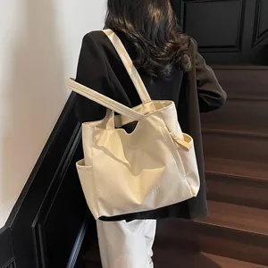 Minimalist cream white tote bag with natural pleated texture and side pockets