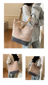 Detail view of large patchwork tote bag featuring metal rivets and pink-grey canvas texture
