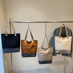 Large capacity canvas tote bags with stylish color contrast and wide straps for commuting