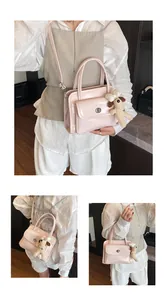 Close-up of pink glossy bowling bag with silver lock and a cute puppy charm