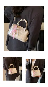 Detail of Boston bag with Chlo Mu embossed letters and pearl bow pendant detail