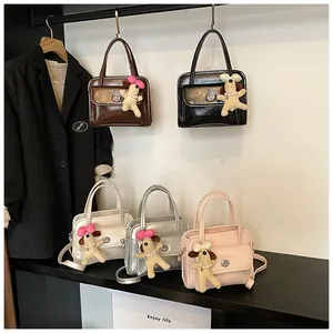 Detail view of stylish bowling bags in five colors with cute puppy plush pendants