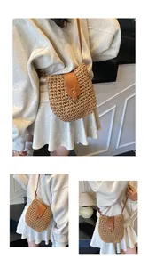Detail of hand-woven straw bucket bag with leather flap and metallic buckle strap