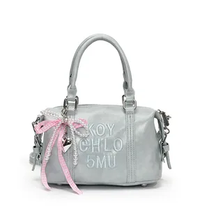 Vintage light blue Boston bag with embroidered letters and a pink plaid bow charm