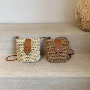 Minimalist hand-woven bucket bag with leather flap and strap in beige and brown colors