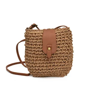 Japanese style woven bucket bag with brown faux leather flap and slim shoulder strap