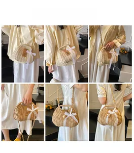 Detail of woven straw bag with white lace bow and brown leather strap for summer vacation