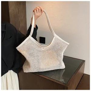 Close-up of the mesh woven texture and durable shoulder strap of the white beach tote
