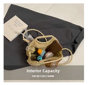 Internal capacity of the straw beach bag showing phone, perfume and cosmetics inside