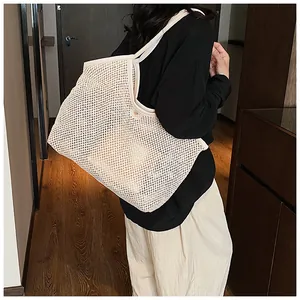 Detailed side view of beige mesh woven tote bag showing large capacity and hollow design