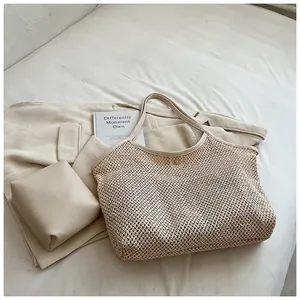 Detail of hand-woven mesh beach bag with internal pouch and metal magnetic clasp