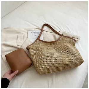 Detail view of woven mesh tote bag with matching brown inner pouch and faux leather straps