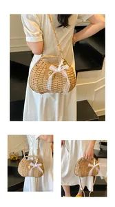 Detailed macro shot of handmade straw bag with delicate white lace bow and brown leather clasp