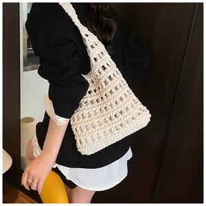 Close-up detail of cream white hand-woven crochet shoulder bag with hollow honeycomb texture