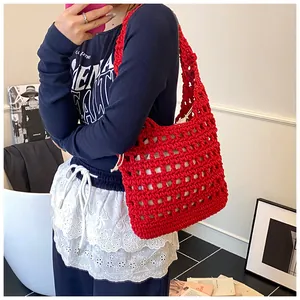 Detail of red hollow crochet tote bag featuring cotton rope weave and white canvas lining