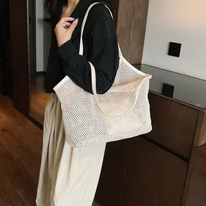 Large cream woven mesh beach tote bag with leather straps for women's vacation style