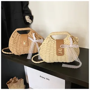 Detail of hand-woven straw bags with faux leather flaps and delicate white lace bows