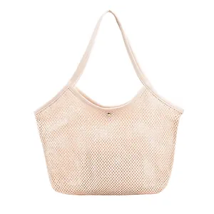 Mesh woven beach tote bag in beige with metallic buckle for seaside summer vacations