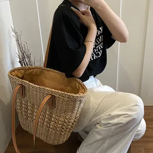 Large handmade straw tote bag with dual leather straps for summer beach vacations