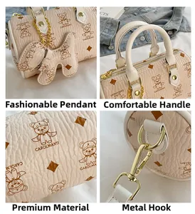 Detail view of beige Boston bag showing lychee grain leather and golden hardware hooks
