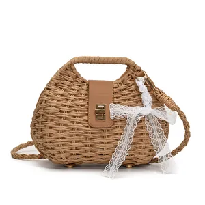 Handwoven straw shoulder bag with leather flap, gold twist lock and lace ribbon detail