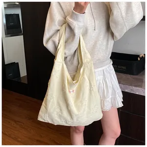 Detail of star pattern jacquard fabric on a cream large capacity shoulder tote bag